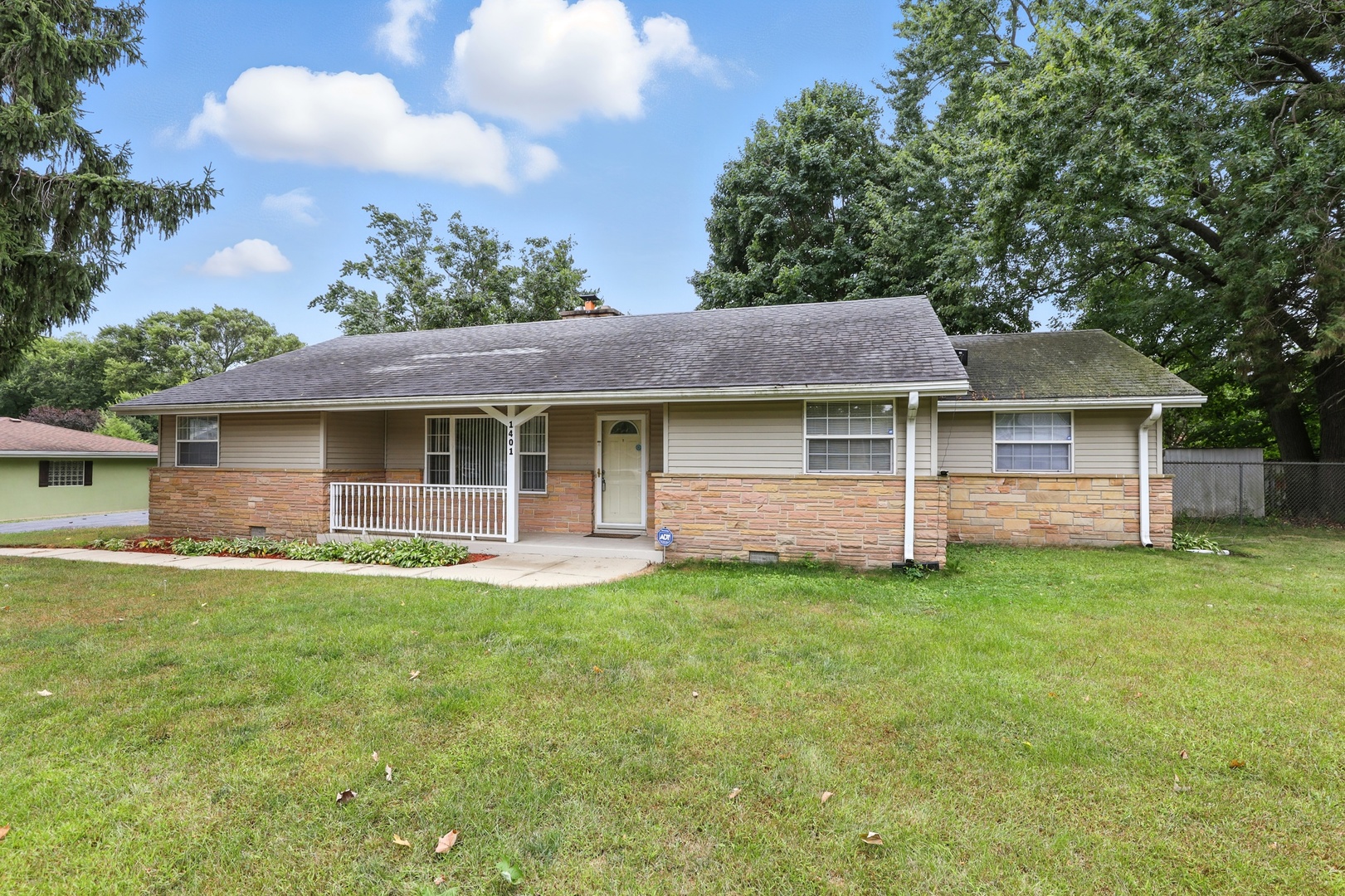 1401 20th Street Zion, IL 60099 - Photo 1 of 30 a front view of a house with a garden