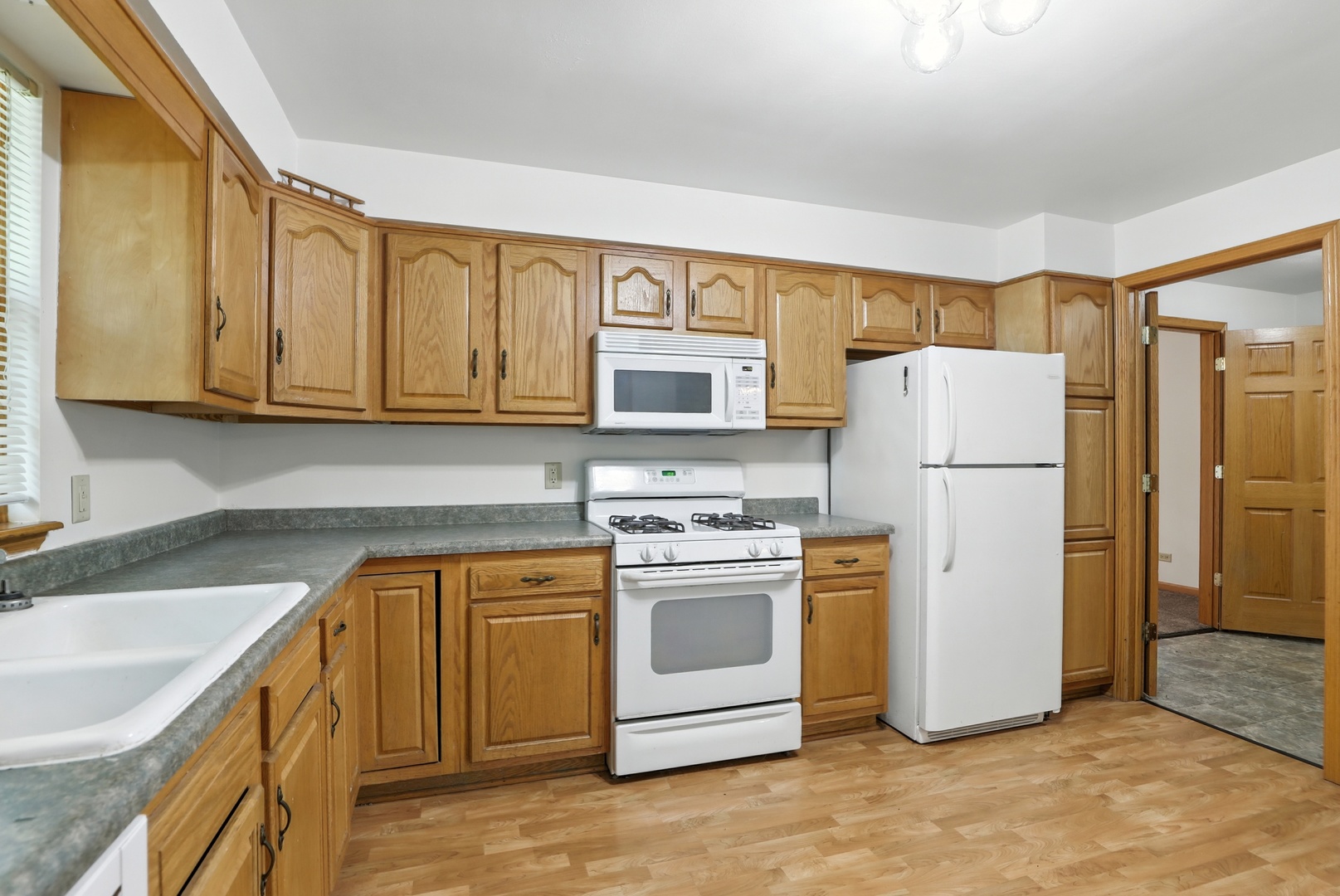 1401 20th Street Zion, IL 60099 - Photo 11 of 30 a kitchen with a refrigerator sink stove and cabinets