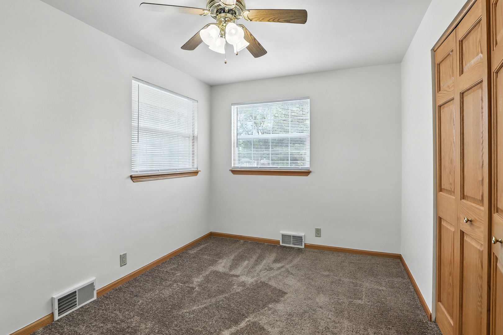 1401 20th Street Zion, IL 60099 - Photo 14 of 30 an empty room with windows and fan