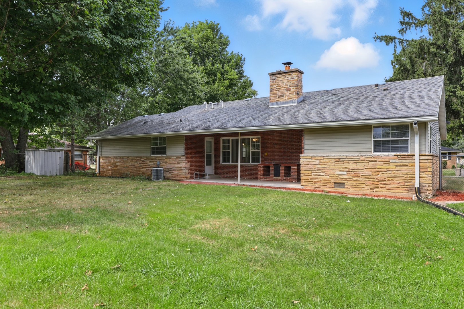 1401 20th Street Zion, IL 60099 - Photo 26 of 30 a front view of a house with a garden