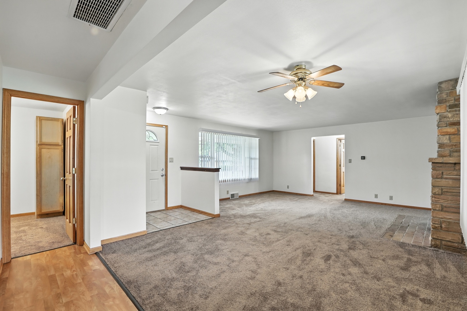 1401 20th Street Zion, IL 60099 - Photo 8 of 30 an empty room with windows and a chandelier fan