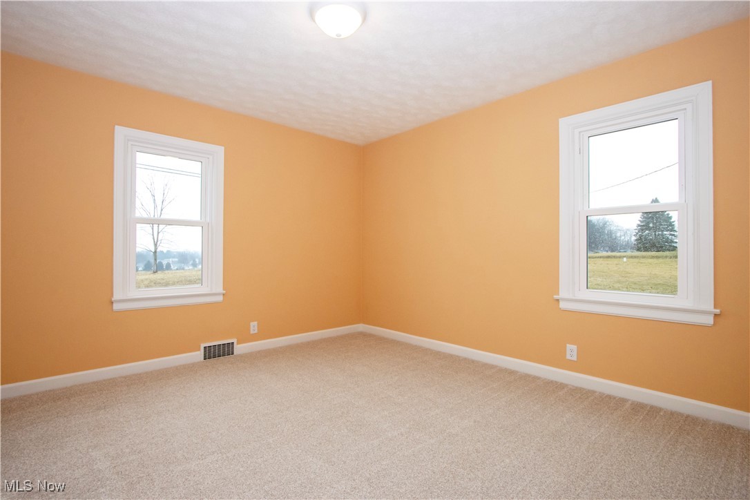 2467 Shreve Road Wooster, OH 44691 - Photo 13 of 27 Empty room with carpet, plenty of natural light, visible vents, and baseboards