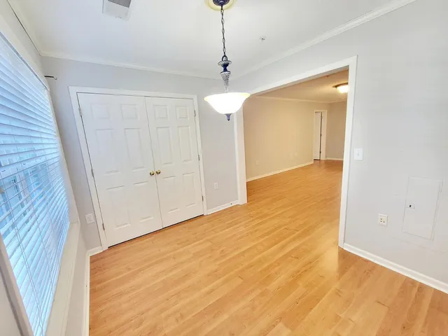 a view of a livingroom with wooden floor and a ceiling fan