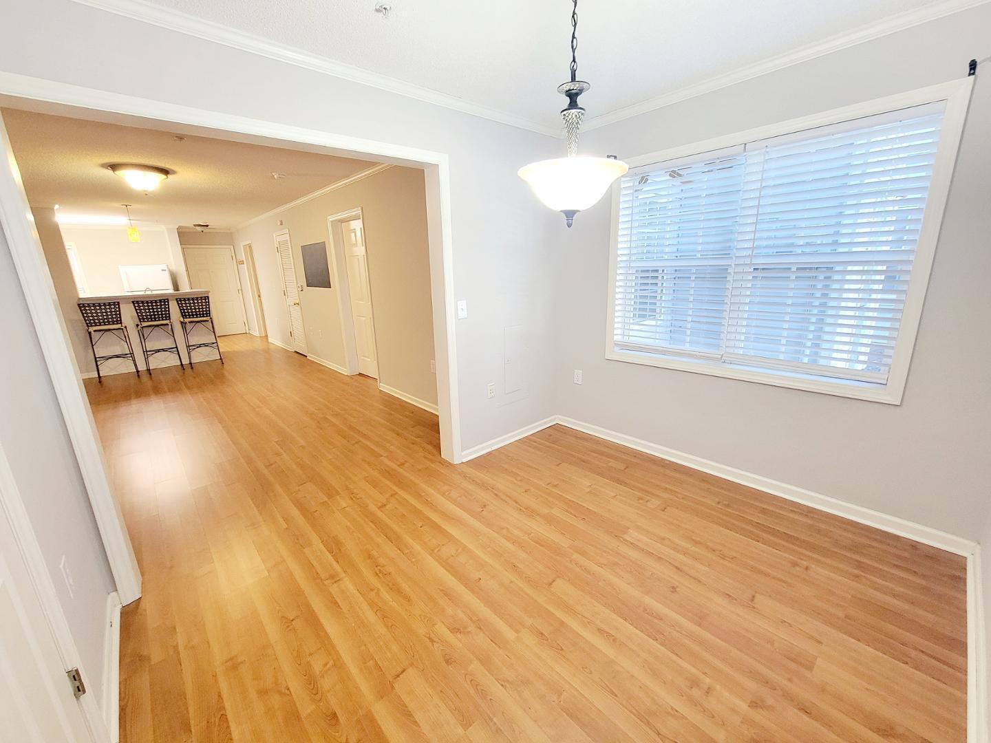 3770 Pardue Woods Place, Unit 103 Raleigh, NC 27603 - Photo 15 of 42 a view of a livingroom with wooden floor and a ceiling fan
