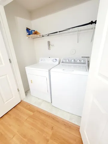 a view of a room with wooden floor