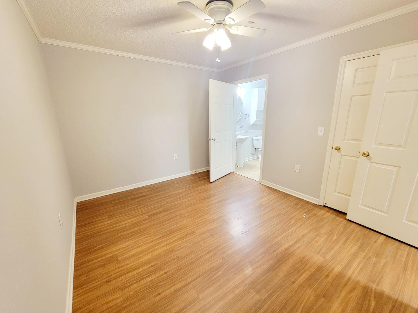 3770 Pardue Woods Place, Unit 103 Raleigh, NC 27603 - Photo 19 of 42 an empty room with wooden floor and windows