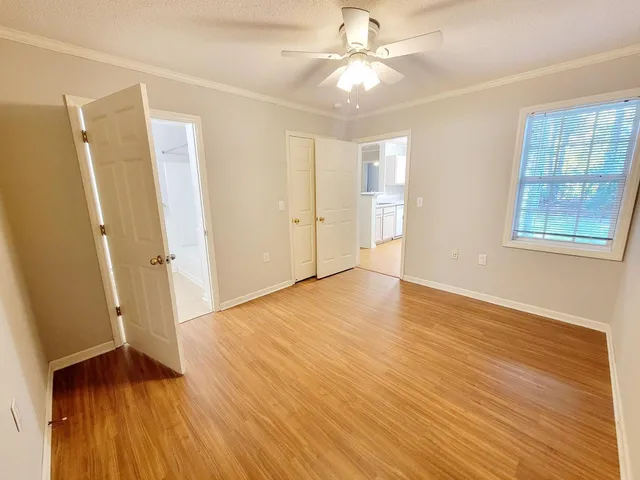 wooden floor in an empty room with a window