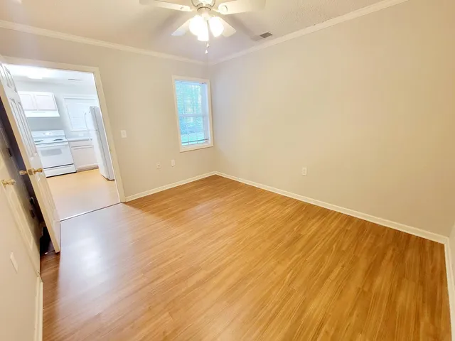 a view of walk in closet with wooden floor