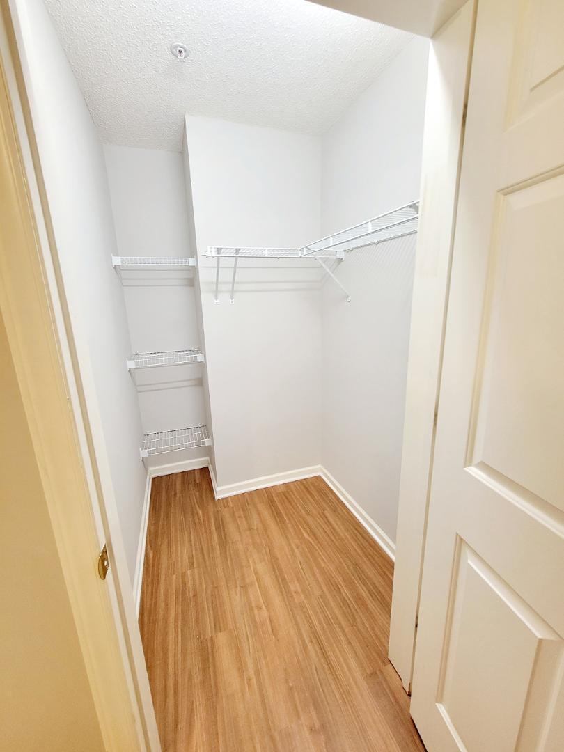 3770 Pardue Woods Place, Unit 103 Raleigh, NC 27603 - Photo 22 of 42 a view of walk in closet with wooden floor
