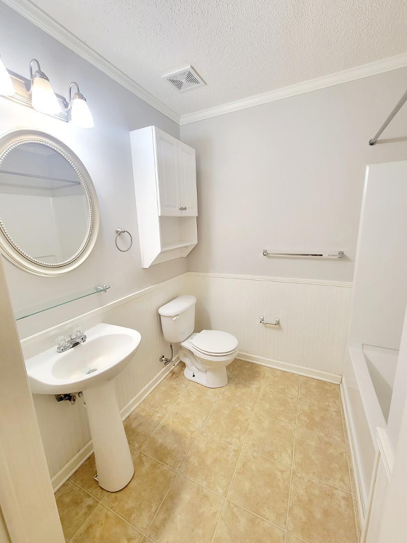 3770 Pardue Woods Place, Unit 103 Raleigh, NC 27603 - Photo 23 of 42 a bathroom with a sink a toilet and a mirror