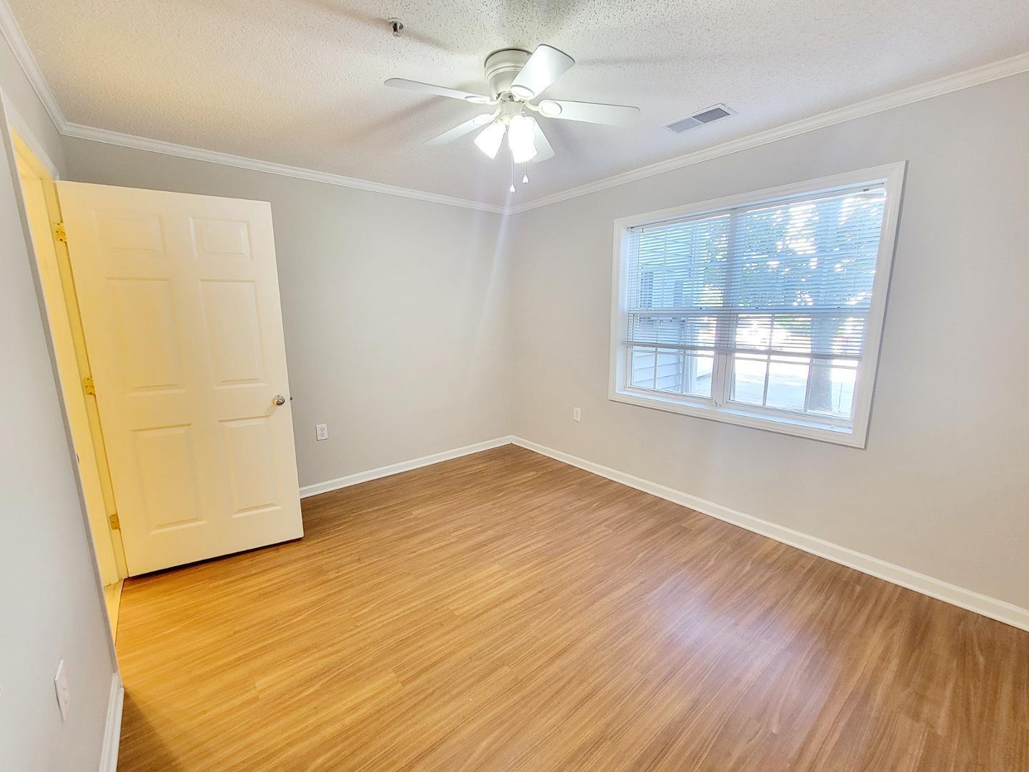 3770 Pardue Woods Place, Unit 103 Raleigh, NC 27603 - Photo 25 of 42 wooden floor in an empty room with a window
