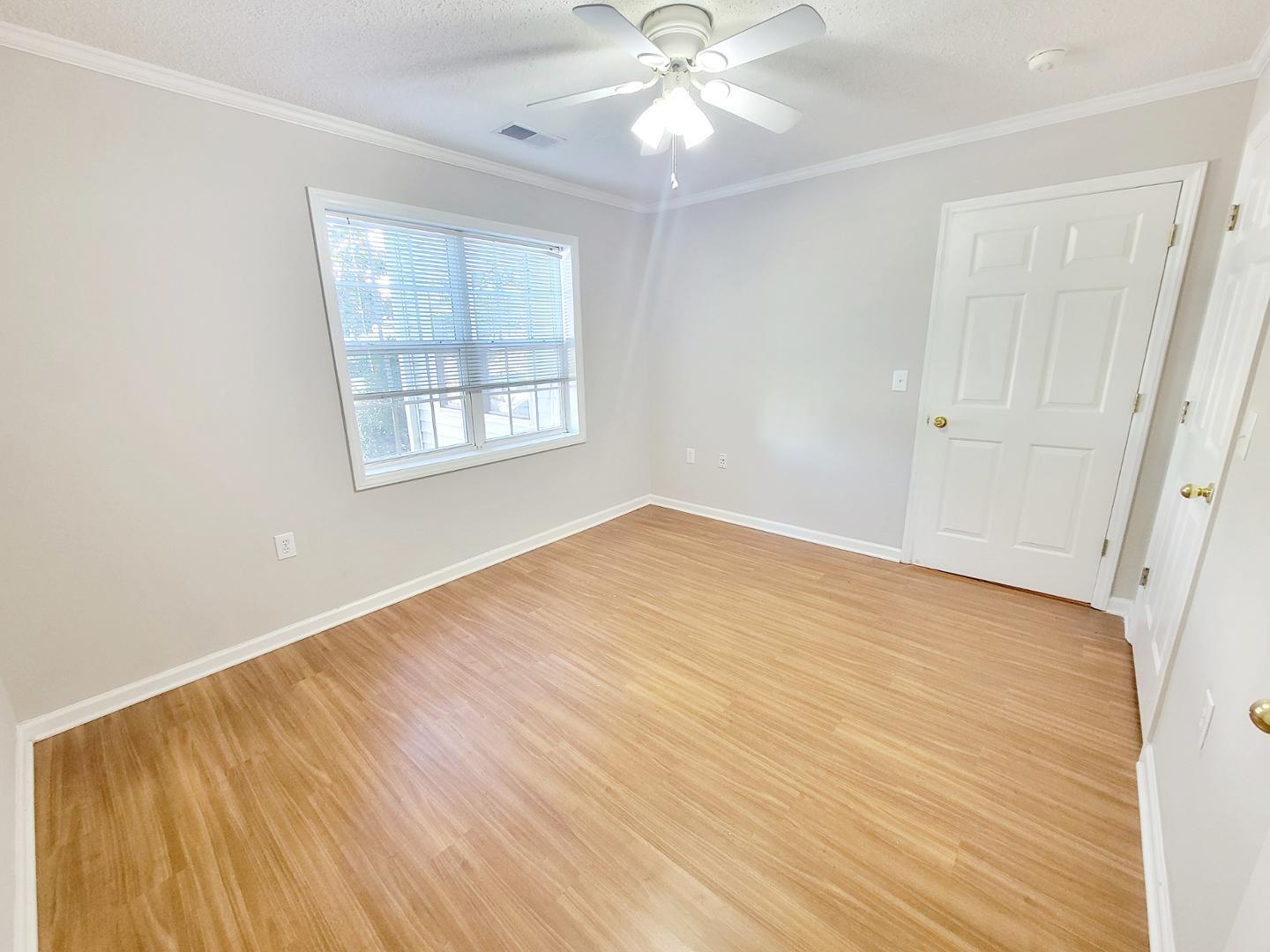 3770 Pardue Woods Place, Unit 103 Raleigh, NC 27603 - Photo 28 of 42 a view of an empty room with wooden floor and a window