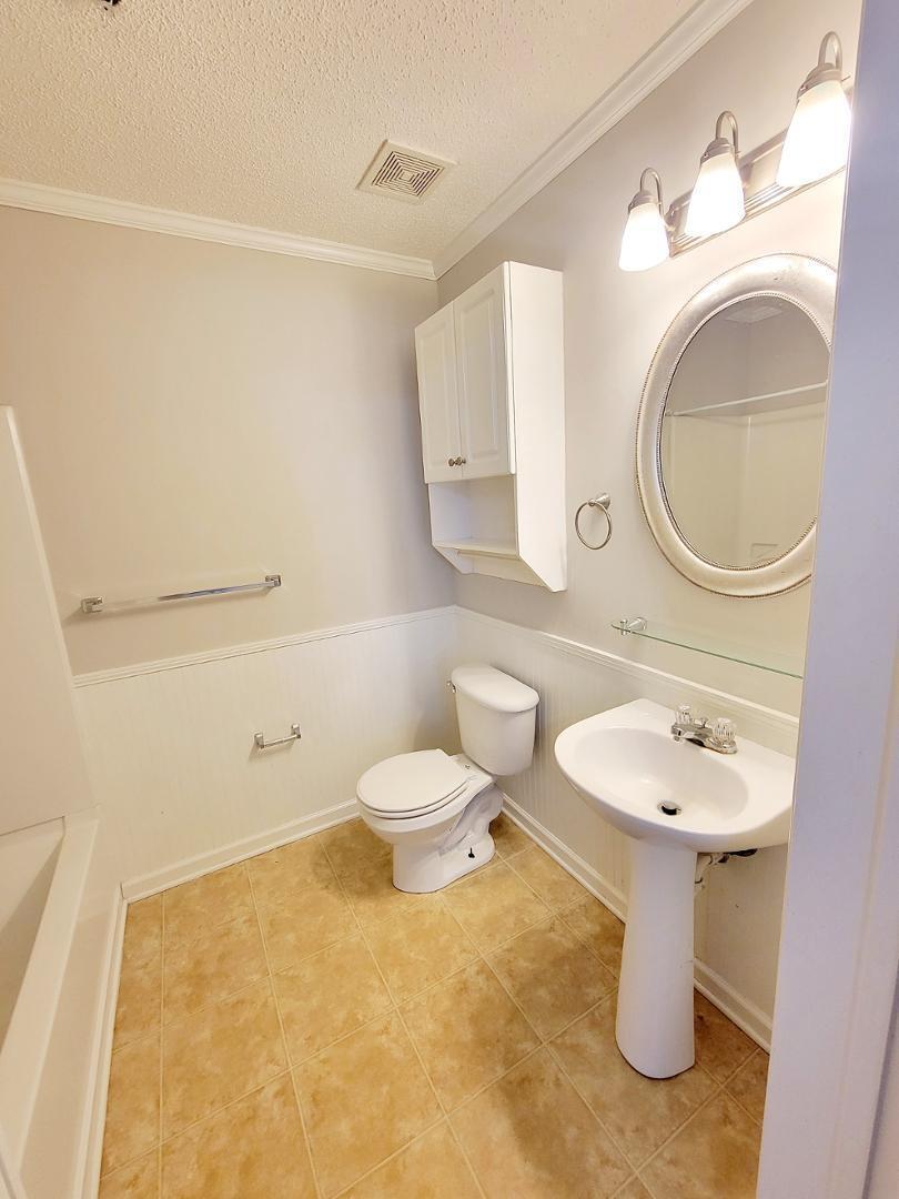 3770 Pardue Woods Place, Unit 103 Raleigh, NC 27603 - Photo 29 of 42 a bathroom with a toilet sink vanity and mirror