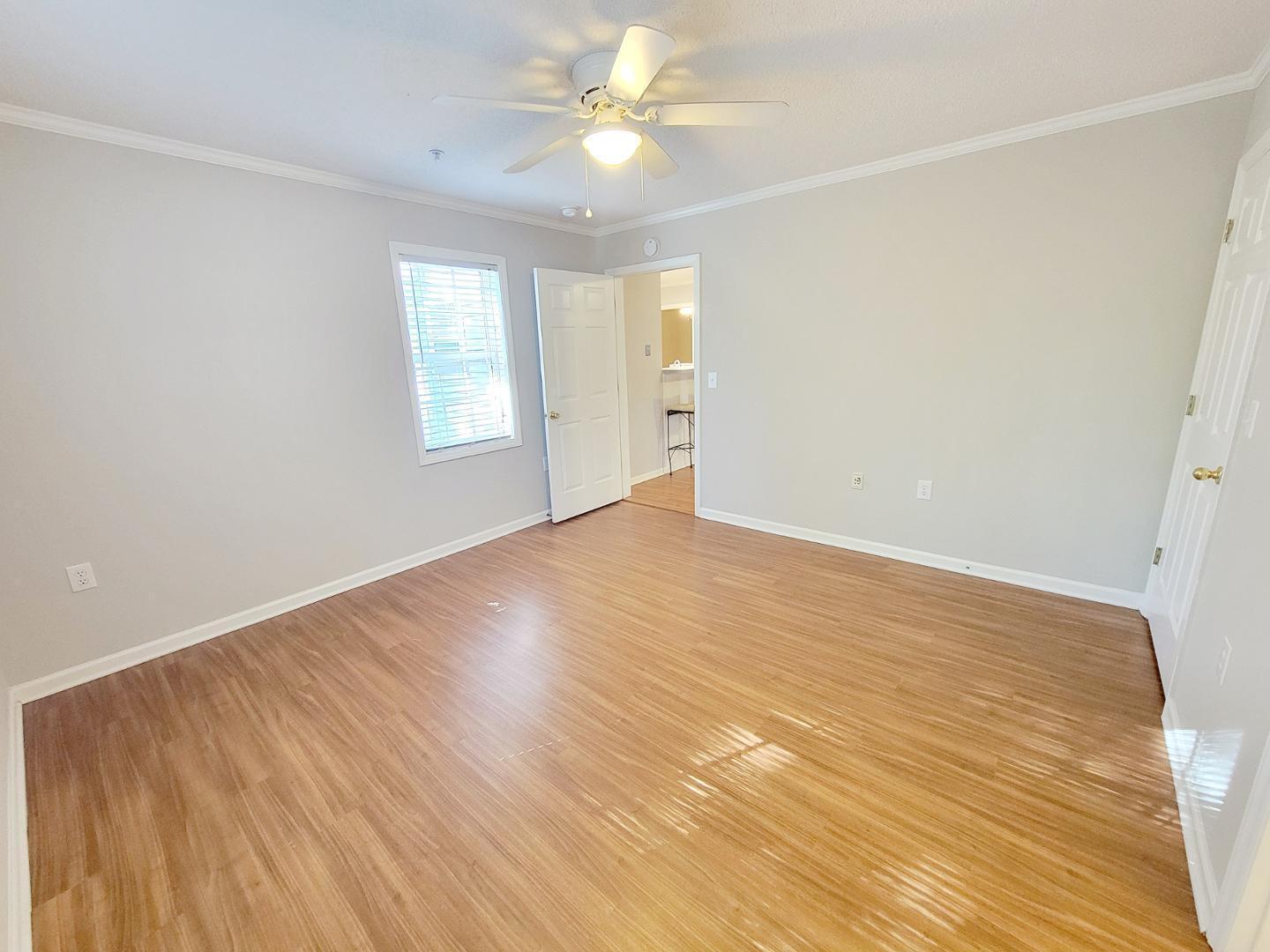 3770 Pardue Woods Place, Unit 103 Raleigh, NC 27603 - Photo 34 of 42 a view of an empty room with window and wooden floor