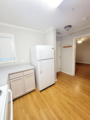 a view of a kitchen with refrigerator and microwave