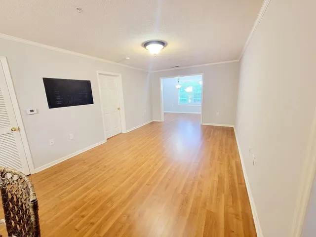 a view of a room with wooden floor