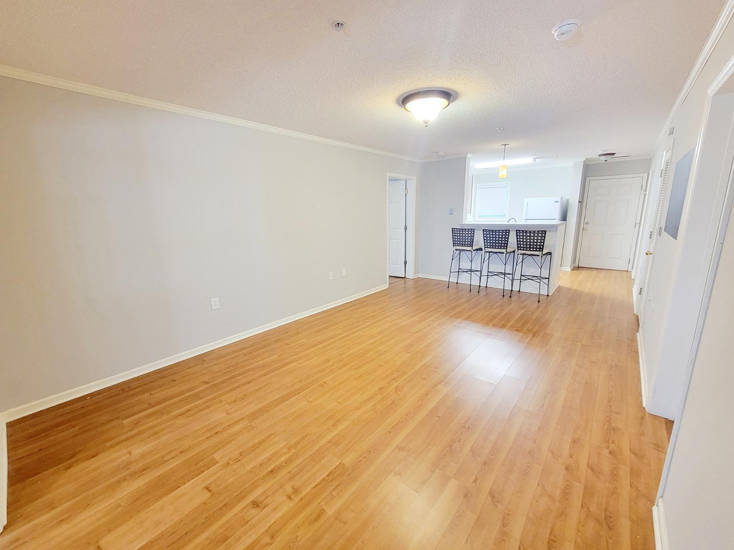 3770 Pardue Woods Place, Unit 103 Raleigh, NC 27603 - Photo 10 of 42 a view of a room with wooden floor and furniture