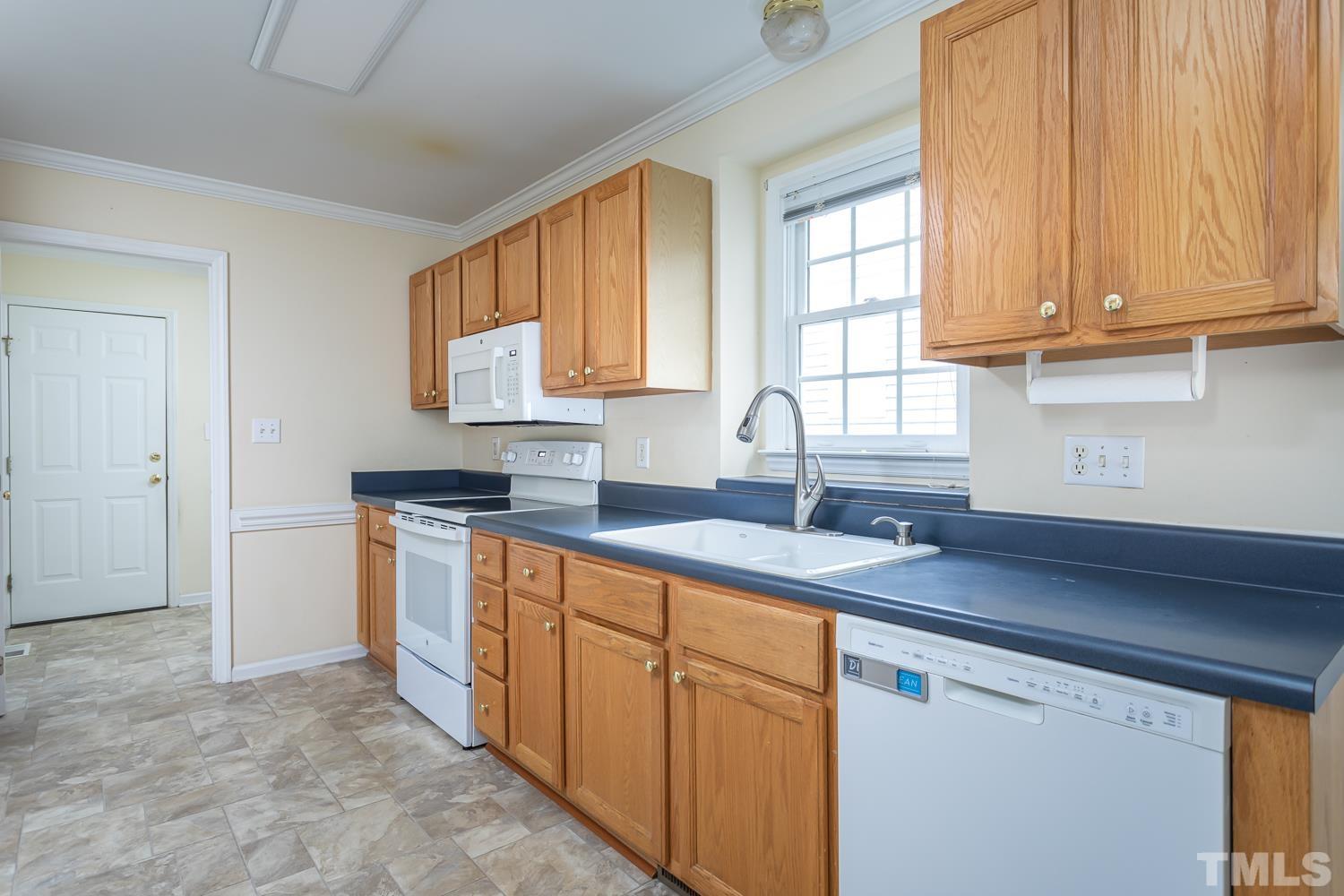 8669 Harps Mill Road Raleigh, NC 27615 - Photo 2 of 13 a kitchen with stainless steel appliances granite countertop a sink stove and cabinets