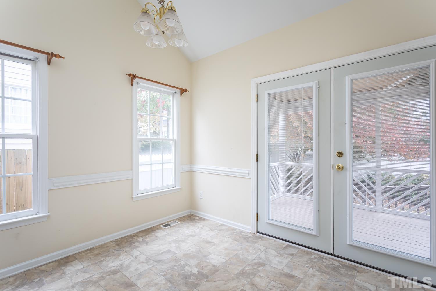 8669 Harps Mill Road Raleigh, NC 27615 - Photo 3 of 13 an empty room with windows and entrance