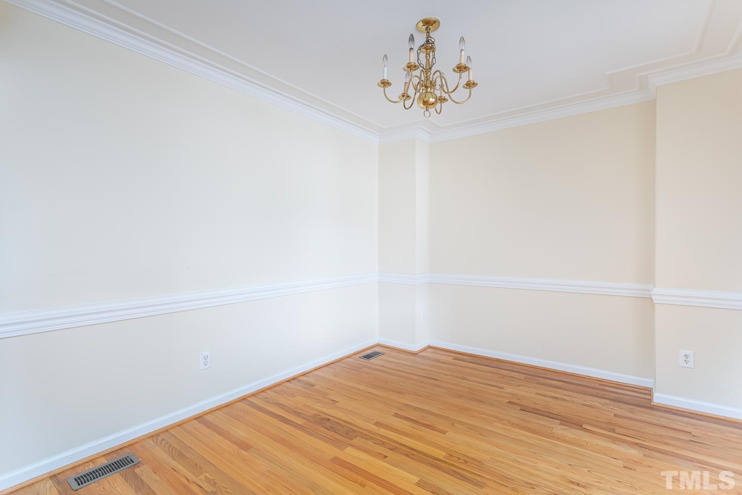 8669 Harps Mill Road Raleigh, NC 27615 - Photo 4 of 13 a view of a room with wooden floor and fan