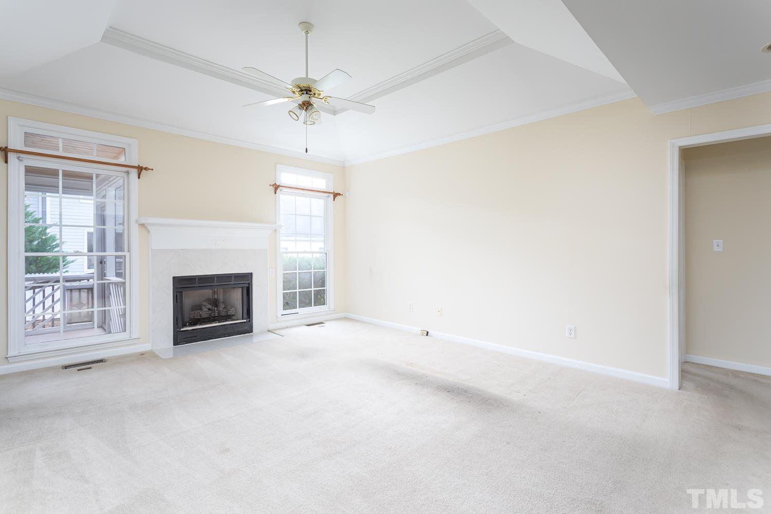 8669 Harps Mill Road Raleigh, NC 27615 - Photo 5 of 13 a view of a livingroom with a fireplace and a window