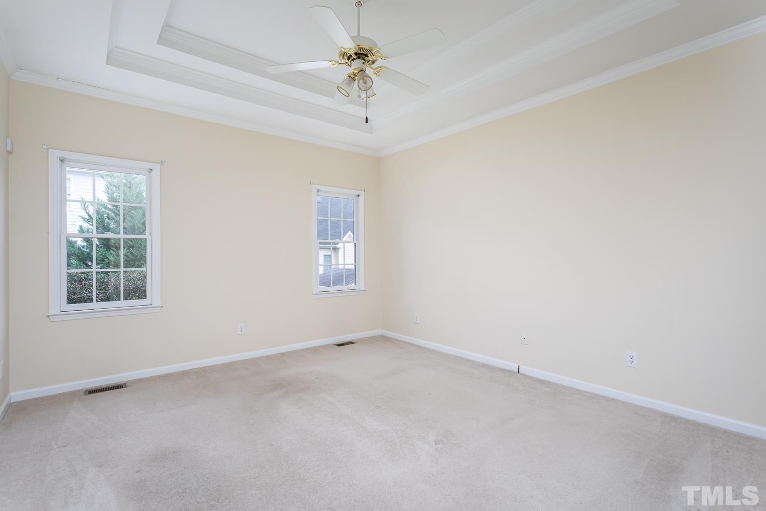 8669 Harps Mill Road Raleigh, NC 27615 - Photo 6 of 13 an empty room with a window and a fan