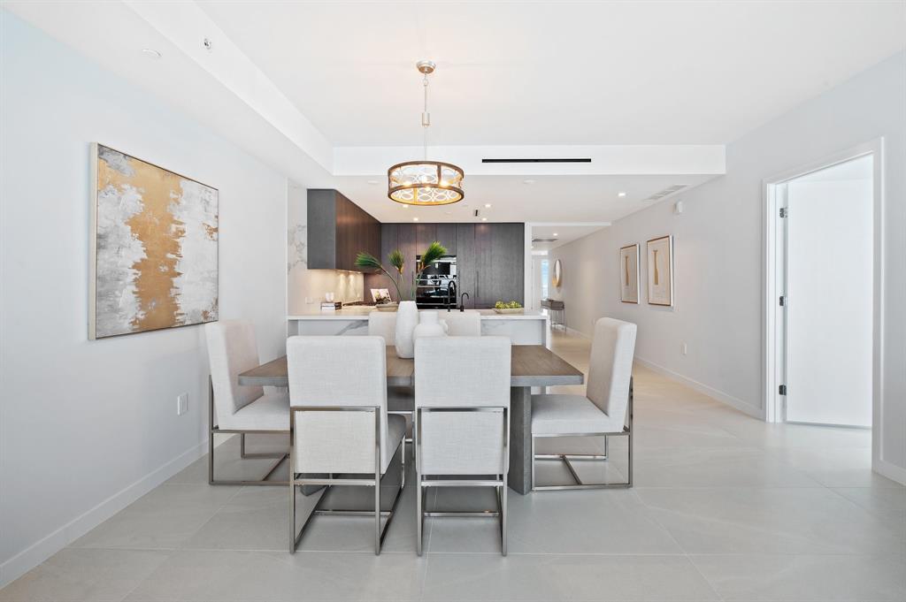 1116 North Ocean Boulevard, Unit 1606 Pompano Beach, FL 33062 - Photo 11 of 83 a dining room with wooden floor a chandelier a wooden table and chairs