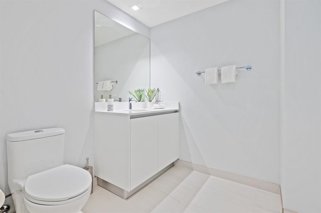 1116 North Ocean Boulevard, Unit 1606 Pompano Beach, FL 33062 - Photo 16 of 83 a bathroom with a sink a toilet and mirror