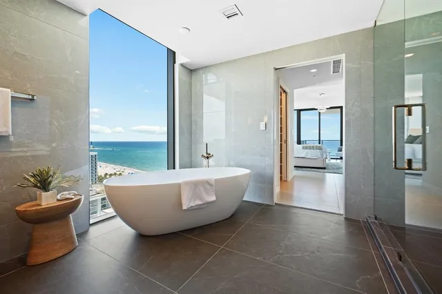 a bathroom with a toilet and a bath tub