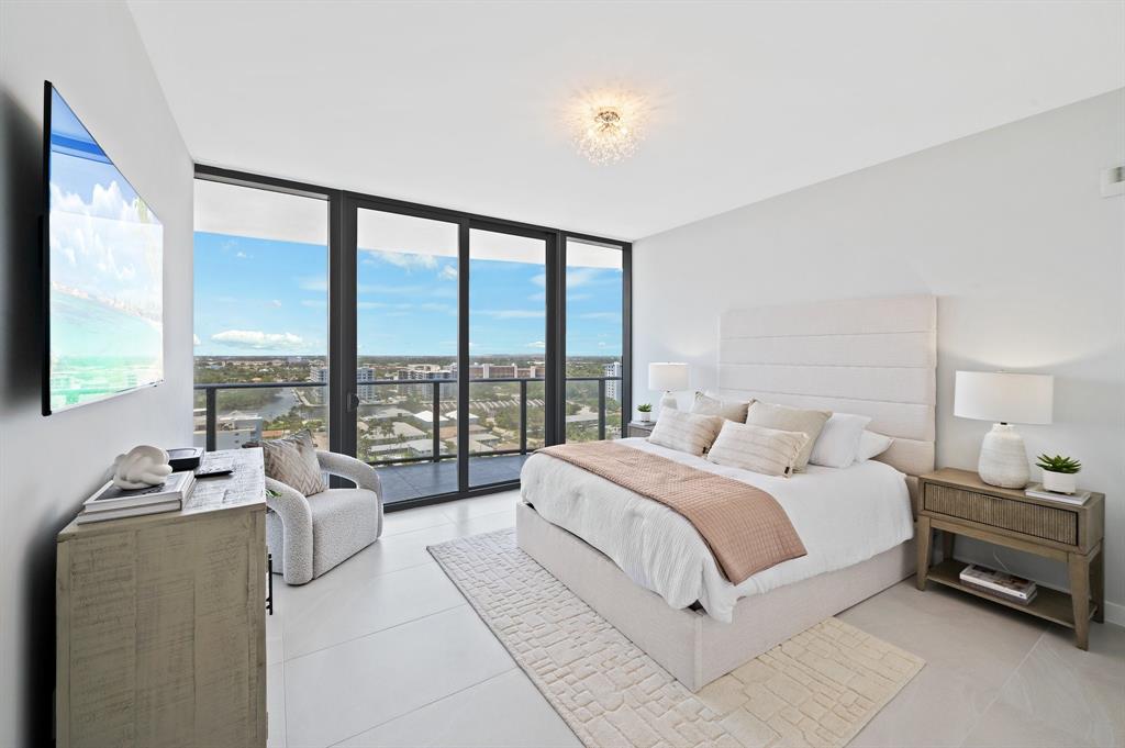 1116 North Ocean Boulevard, Unit 1606 Pompano Beach, FL 33062 - Photo 22 of 83 a spacious bedroom with a large bed and a large window
