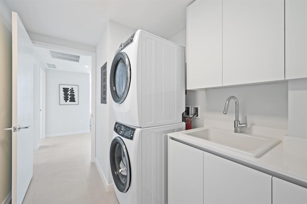 1116 North Ocean Boulevard, Unit 1606 Pompano Beach, FL 33062 - Photo 29 of 83 a utility room with sink dryer and washer