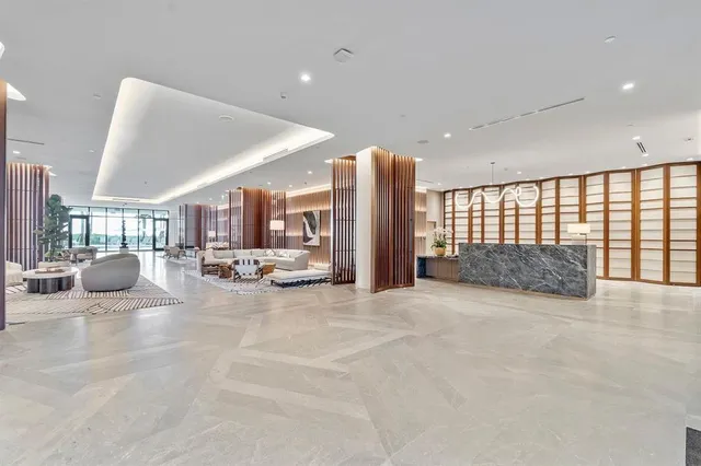 a living room with lots of furniture and view of kitchen