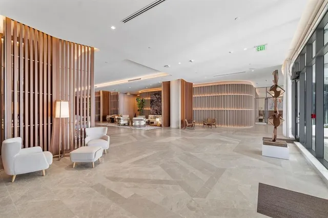 a living room with furniture a couch and a ceiling fan