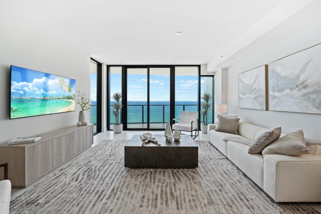 1116 North Ocean Boulevard, Unit 1606 Pompano Beach, FL 33062 - Photo 4 of 83 a living room with furniture and a flat screen tv