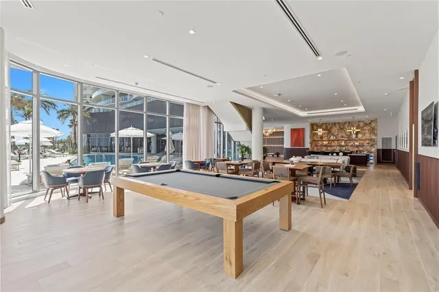 a view of a dining room with furniture a rug and wooden floor