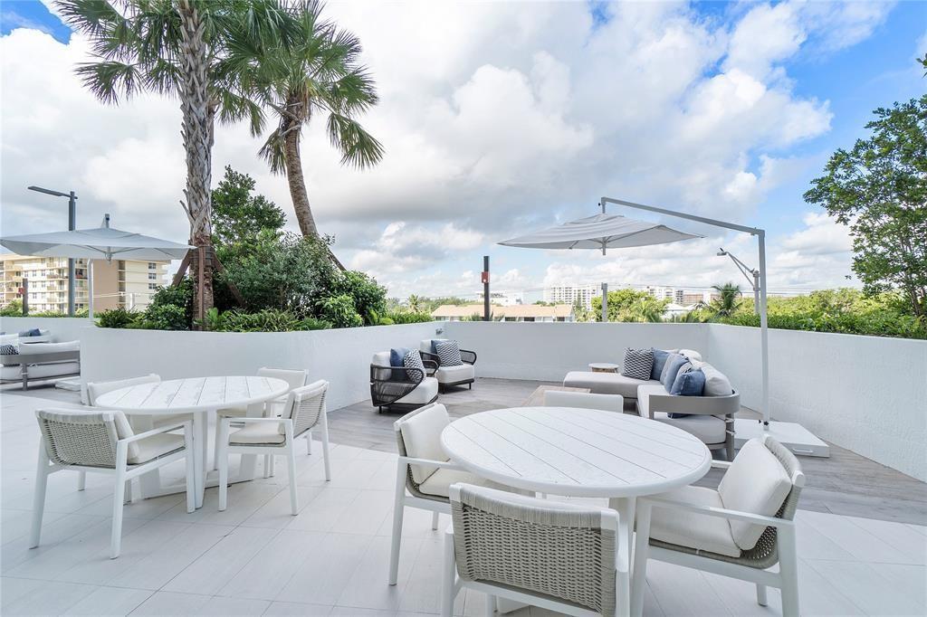 1116 North Ocean Boulevard, Unit 1606 Pompano Beach, FL 33062 - Photo 68 of 83 a terrace with outdoor seating and city view