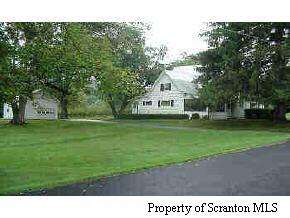 a view of house with a yard