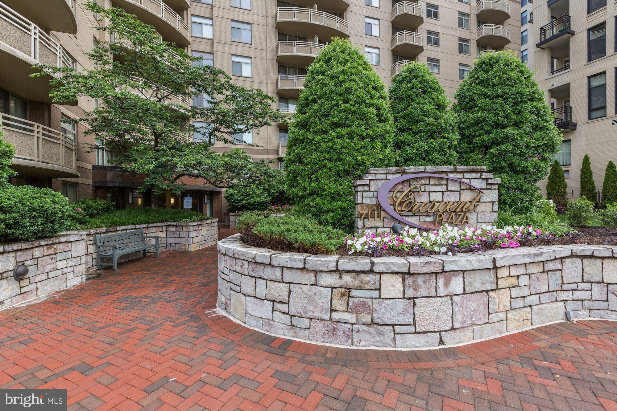 7111 Woodmont Avenue, Unit 708 Bethesda, MD 20815 - Photo 2 of 6 a view of a wooden bench next to a building