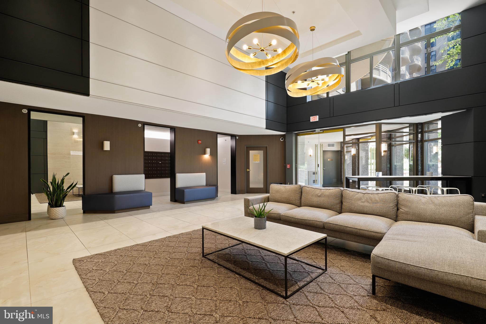 7111 Woodmont Avenue, Unit 708 Bethesda, MD 20815 - Photo 4 of 6 a living room with furniture a clock and a large window