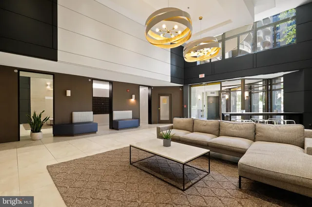 a living room with furniture a clock and a large window