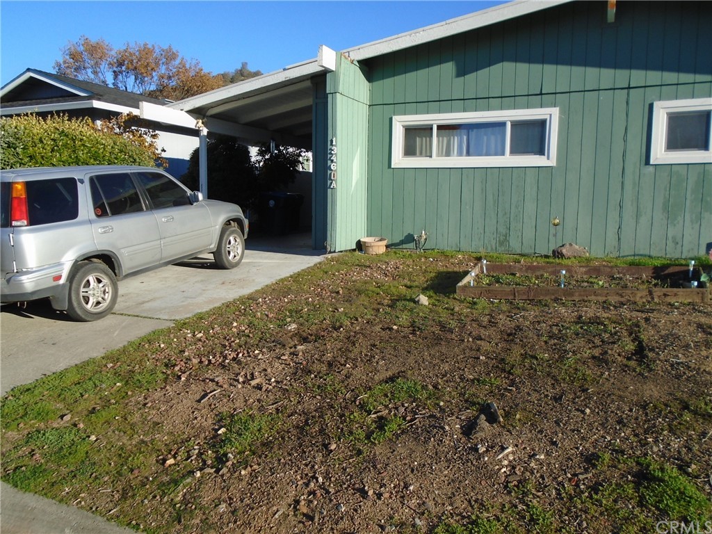 a front view of a house with parking area