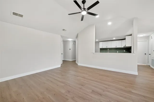a view of a kitchen with a dishwasher and a refrigerator