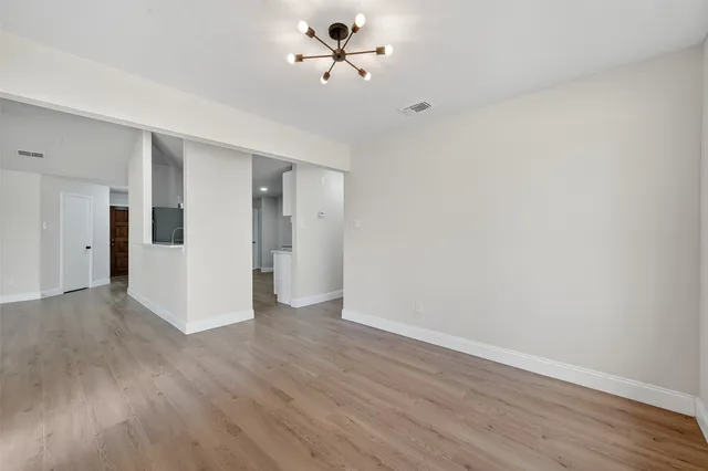a view of a livingroom with wooden floor and a ceiling fan