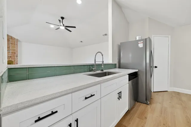 a kitchen with a sink and cabinets