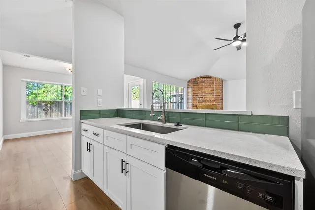 a kitchen with a sink stove and cabinets