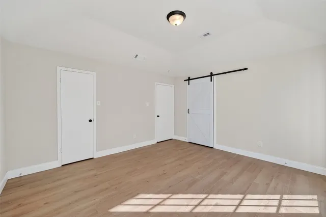 a view of a room with wooden floor