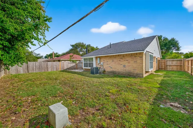 a view of a backyard with a garden and entertaining space