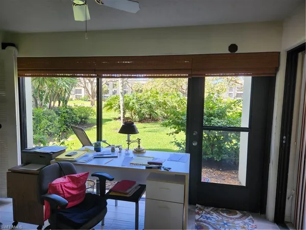 a living room with furniture flat screen tv and a bookshelf