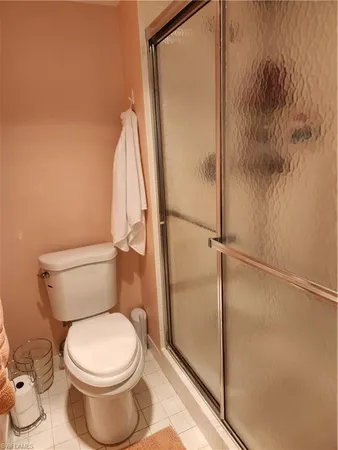 a bathroom with a toilet and a shower