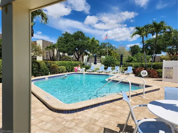a living room with furniture and a book shelf